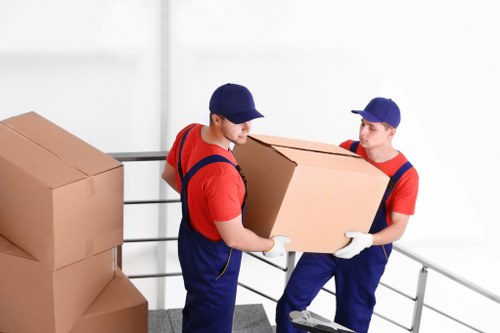 Packing boxes and organising belongings for a move in Brent