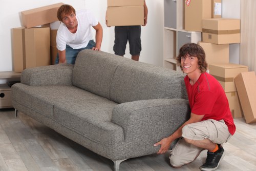 Removalists handling household items during a local Brent house move