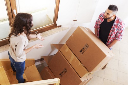 Mover assessing stairs and route risks before lifting furniture