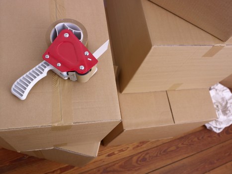 Packed moving boxes and furniture prepared for a home removal in Brent